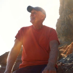 Older man sitting down outdoors